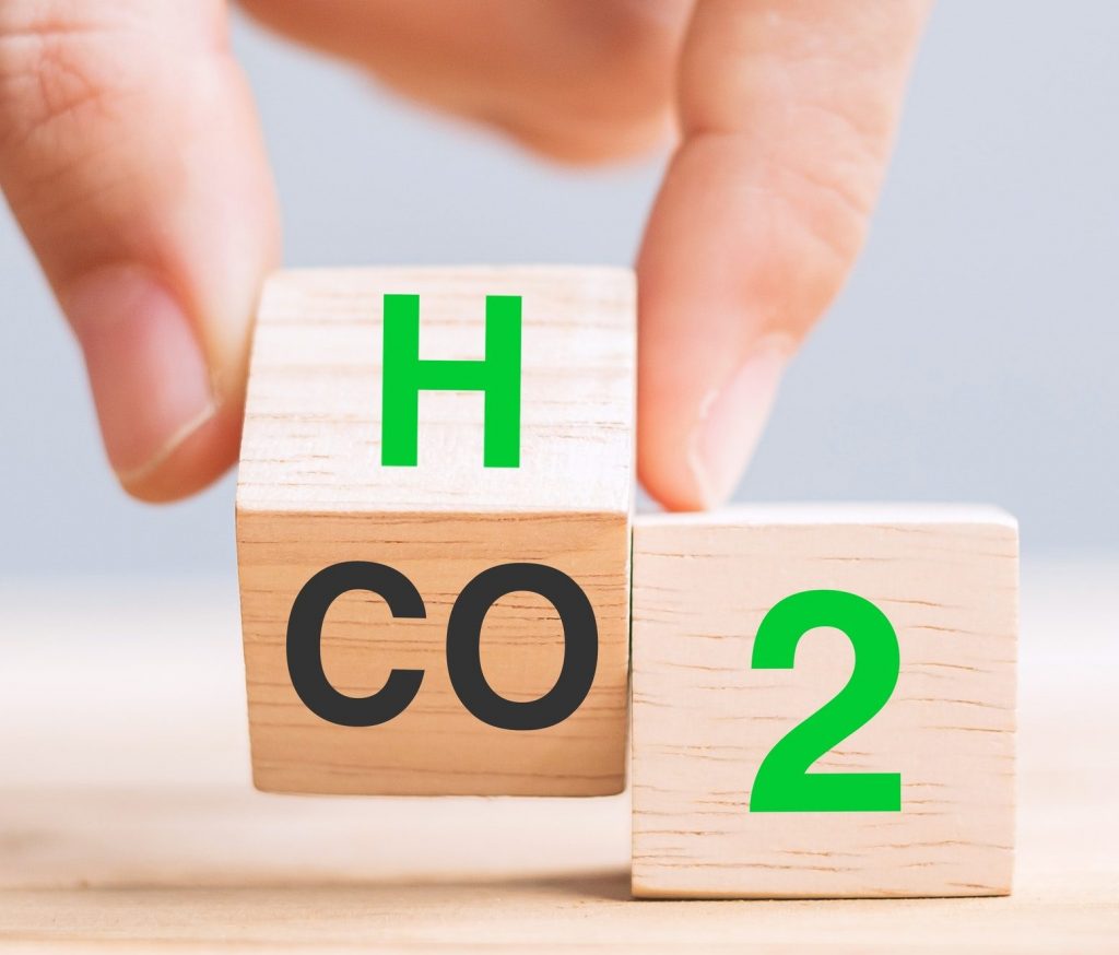 hand flipping blocks with CO2 (Carbon dioxide), change to H2 (Hydrogen) text. Free Carbon concepts
